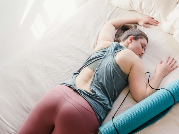 A person in a relaxed yoga pose, implying calmness and good sleep.