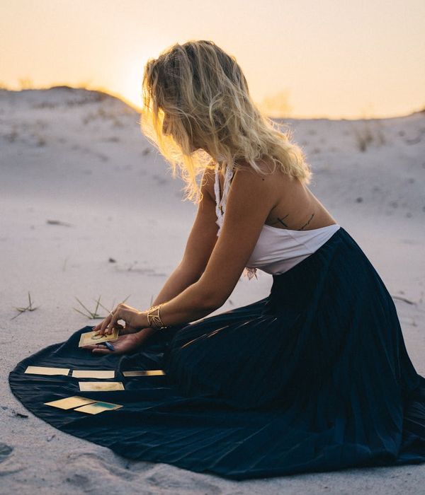 Woman meditating in a serene evening setting, bathed in gentle light.